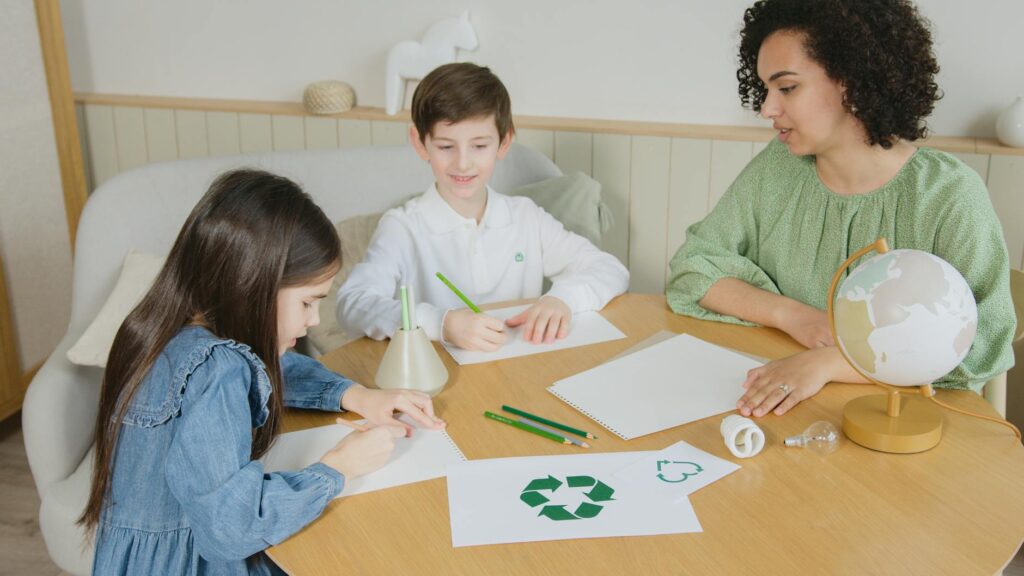 woman in green long sleeve shirt sitting beside boy in white shirt