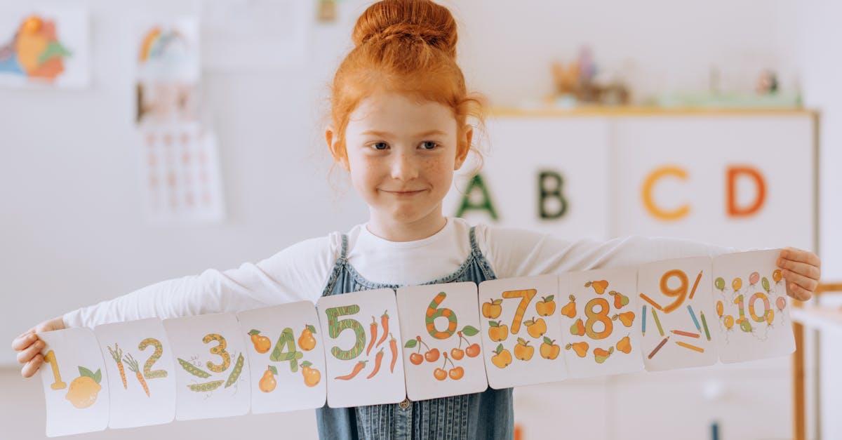 Young girl showcasing number cards in a vibrant classroom setting.